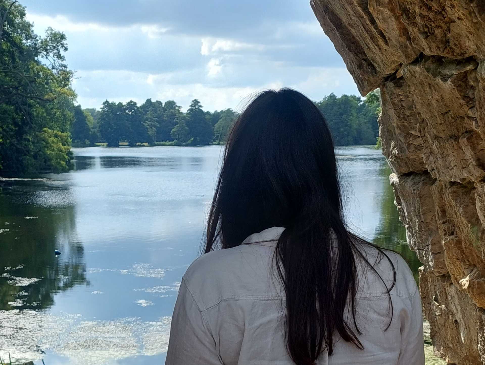 Ana Lucia looking at the horizon in front of a beautiful lake